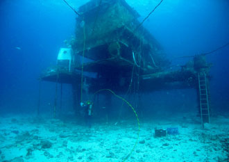 A NEEMO 11 crew member works near the undersea habitat "Aquarius" during a session of extravehicular activity for the NEEMO project. Image credit: NASA