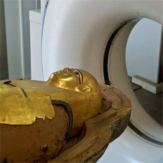 A mummy entering a CT scanner